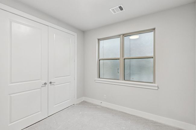 Secondary bedroom with baseboards and a closet | Image 22