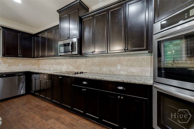 Double oven, microwave, cooktop, dishwasher and refrigerator (not shown in this photo) all stainless steel. | Image 18