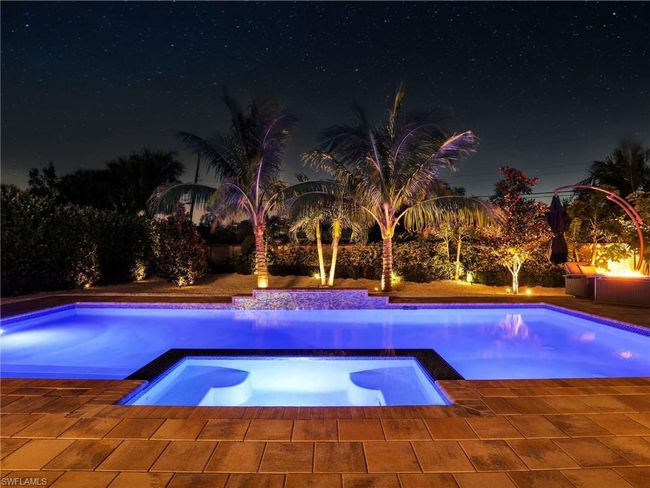 Pool at twilight with an in ground hot tub | Image 42