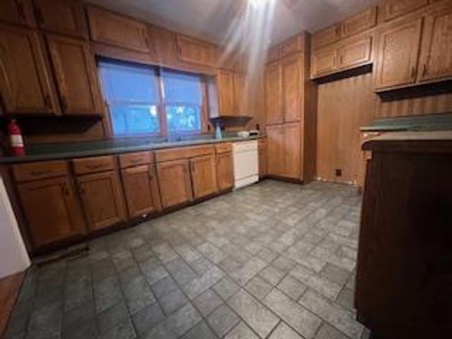 Kitchen featuring dishwasher, brown cabinets, and ceiling fan | Image 4