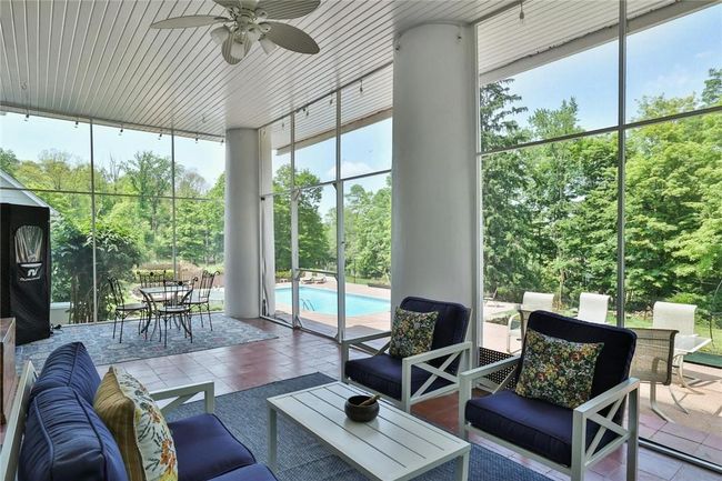 Screen porch with access from the kitchen and dining room as well as to pool and patio | Image 14