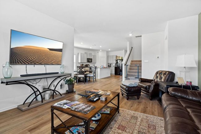 Living area featuring recessed lighting, light wood-style flooring, baseboards, and stairs | Image 4