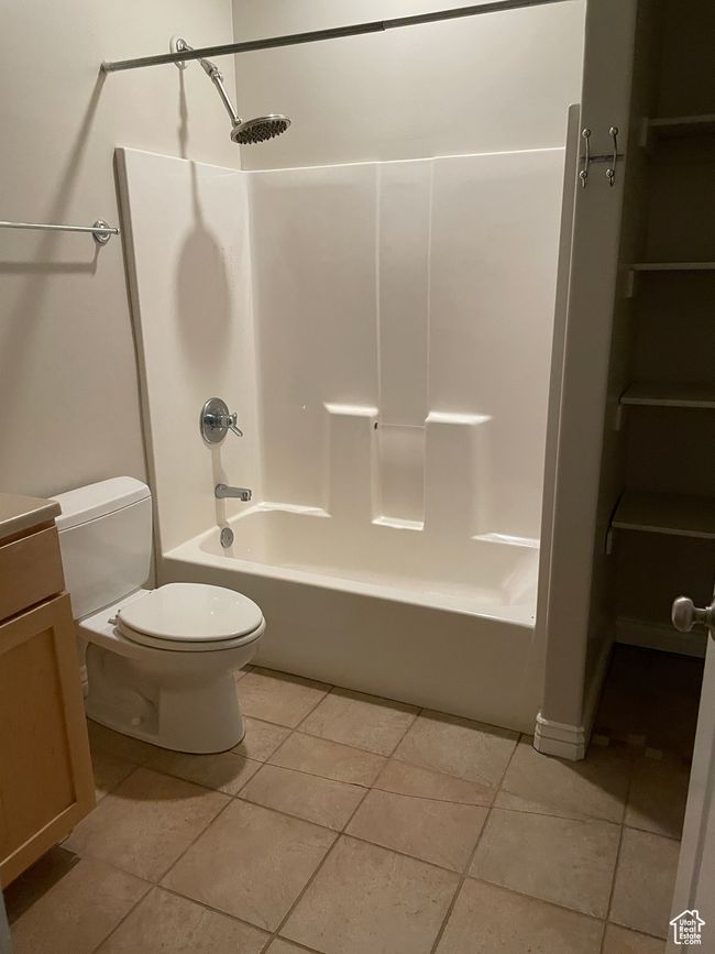 Full bath featuring washtub / shower combination, tile patterned flooring, and vanity | Image 19