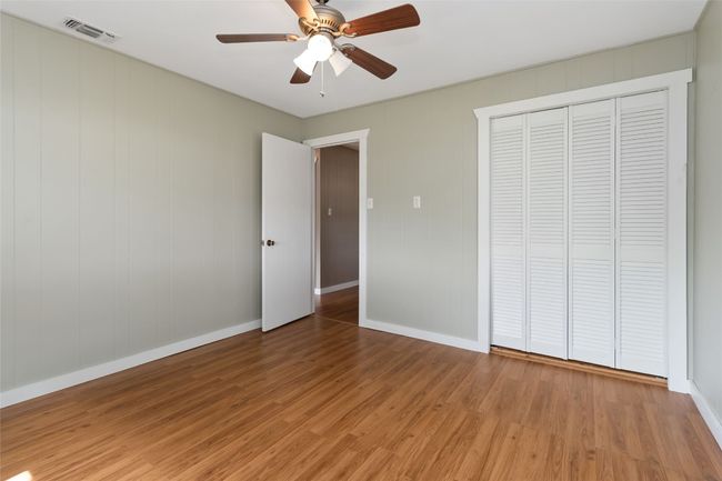 Unfurnished bedroom with light wood-style flooring, a closet, ceiling fan, and visible vents | Image 16