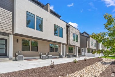 Back of property with cooling unit and a patio area | Image 1