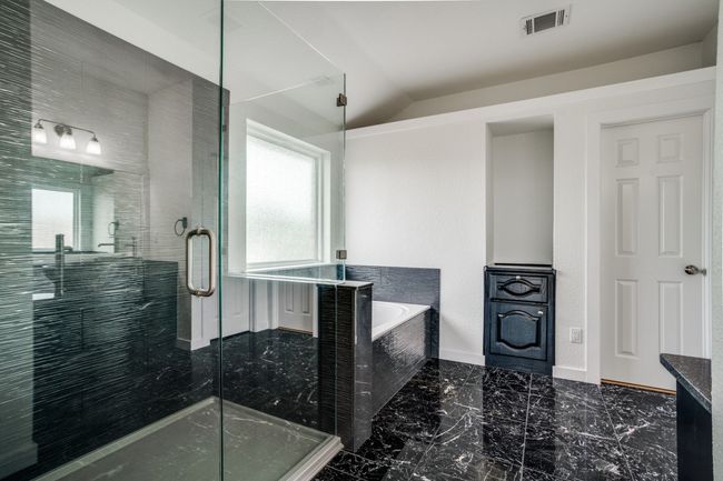 Full bathroom with a garden tub, a stall shower, marble tiled floors, lofted ceiling, and baseboards | Image 30