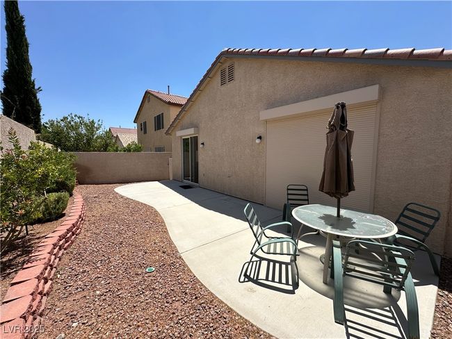 Rear view of property with stucco siding, a patio, a fenced backyard, and a tile roof | Image 29
