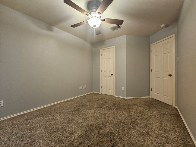 Carpeted spare room with ceiling fan and a smoke detector | Image 24