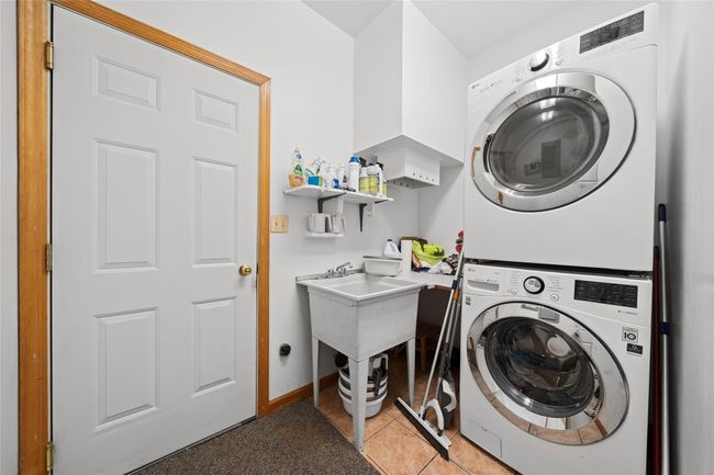 Clothes washing area featuring stacked washer / drying machine and laundry area | Image 41