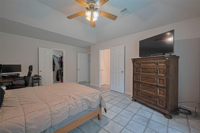 Spacious downstairs primary bathroom features serene views of the pool, offering a relaxing retreat just steps from the main suite. | Image 17