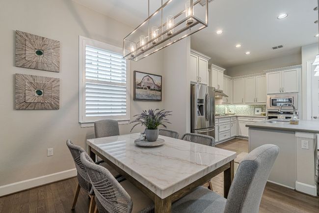 Dining area with wood finished floors, recessed lighting, baseboards, and a chandelier | Image 11