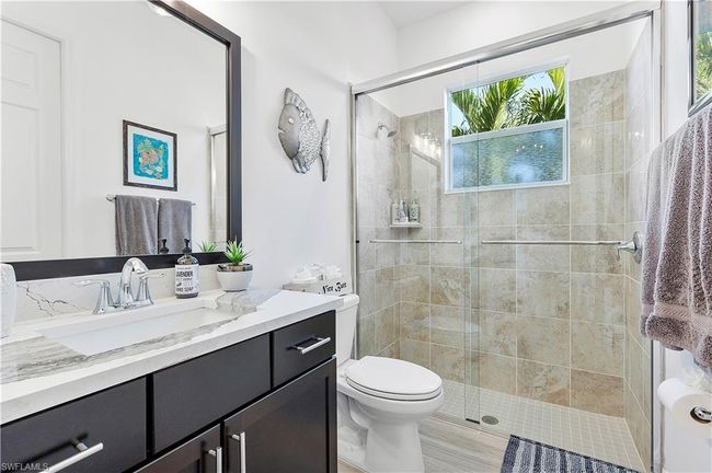 Full bath featuring a shower stall, vanity, and toilet | Image 42