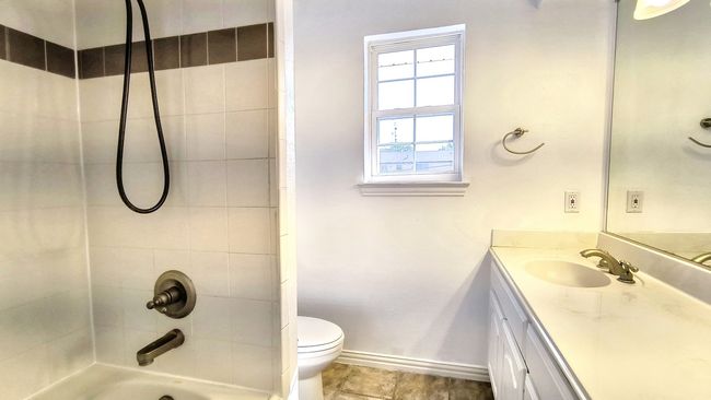 Full bathroom featuring vanity, tiled shower / bath combo, and toilet | Image 29