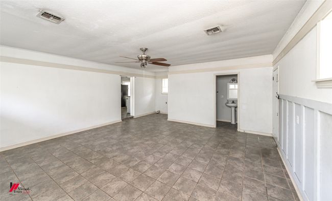 Spare room with a textured ceiling, visible vents, and a ceiling fan | Image 30