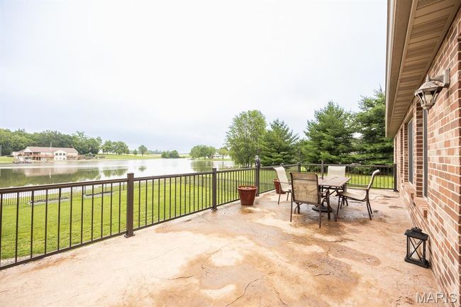 View of patio featuring a water view and outdoor dining space | Image 42