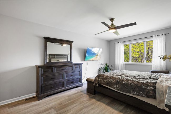 Bedroom featuring light wood-style flooring and ceiling fan | Image 32