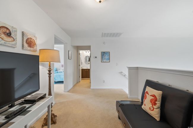 Living area with light colored carpet and baseboards | Image 26