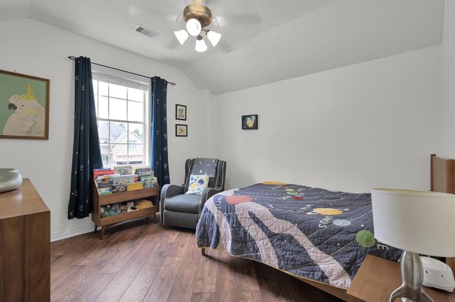 Bedroom 4, with the ensuite bath, faces the front of the home and gives a great view of the front yard and golf course across the street. | Image 33