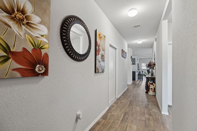 Hall with wood-vinyl finished floors and baseboards | Image 7