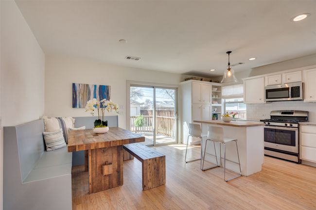 Kitchen with open shelves, wood counters, appliances with stainless steel finishes, and light wood finished floors | Image 10