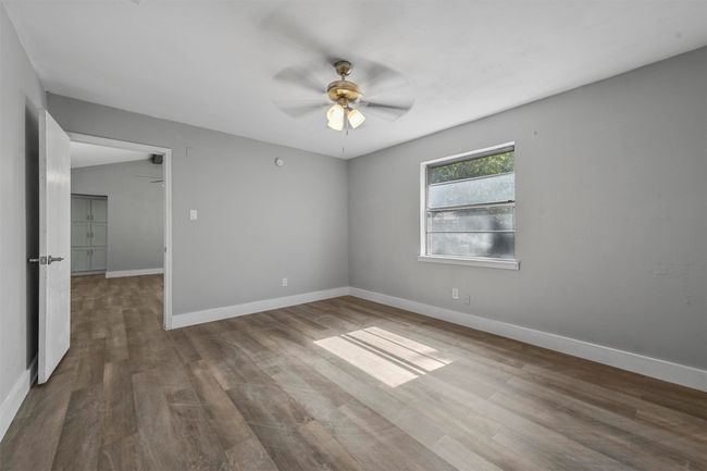 Unfurnished room featuring ceiling fan and wood-type flooring | Image 21