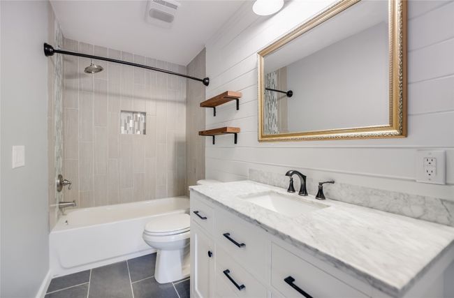 Full bathroom with tile patterned floors, vanity, and bathtub / shower combination | Image 20