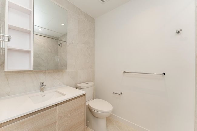 Bathroom featuring vanity, tile patterned floors, walk in shower, toilet, and tile walls | Image 18