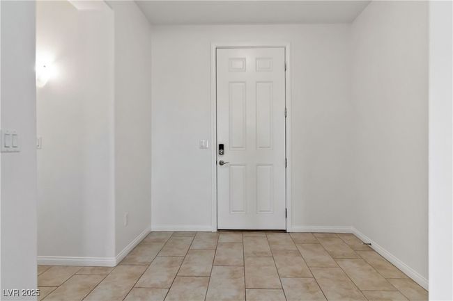 Spare room featuring light tile patterned floors and baseboards | Image 11