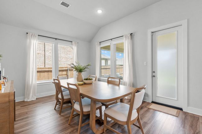 Dining area featuring light wood finished floors, vaulted ceiling, and recessed lighting | Image 17