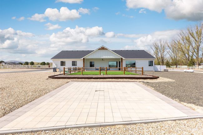 Modern farmhouse style home featuring a patio area, a wooden deck, and board and batten siding | Image 40