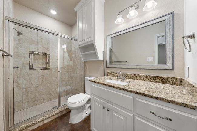 Bathroom with vanity and a shower stall | Image 11