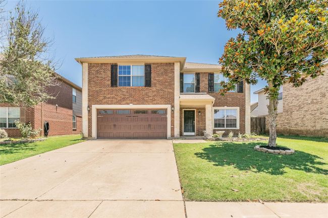 View of front facade with a garage, brick siding, a front yard, and concrete driveway | Image 18