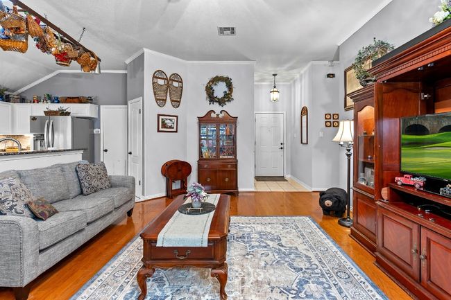 Living room with ornamental molding, sink, and light hardwood / wood-style floors | Image 9