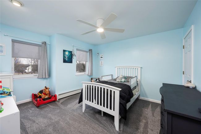 Carpeted bedroom with ceiling fan | Image 25