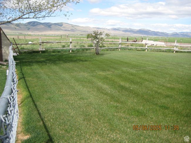 View of yard with a mountain view, a rural view, and fence | Image 10