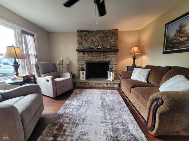 Family room with cozy gas log fireplace and great window view. | Image 36