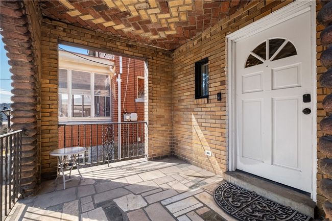 Gorgeous Covered front porch w/ round archways and original brick pavers. | Image 4
