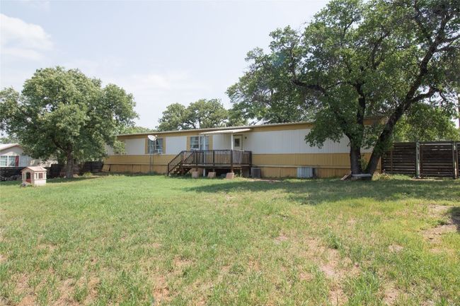 View of yard featuring a wooden deck | Image 19