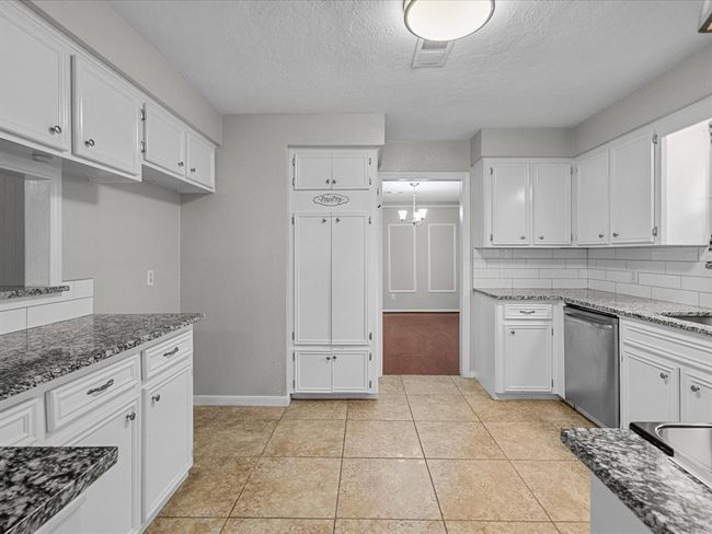 Enjoy lots of counterspace, stainless steel appliances, crisp white cabinetry, and granite countertops. | Image 6