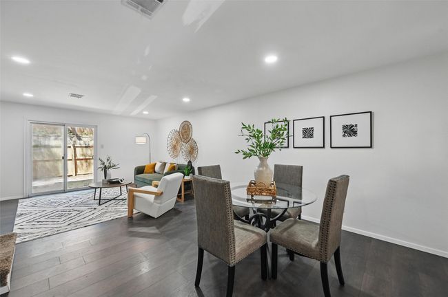 Dining space with dark wood finished floors, visible vents, and recessed lighting | Image 10