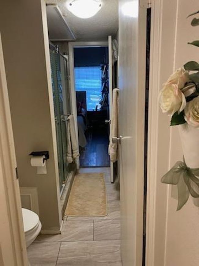 Primary bathroom with dual entrance from primary bedroom and family room. | Image 8