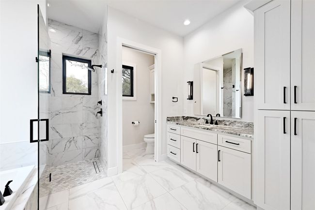 Full bath featuring toilet, marble finish floor, a marble finish shower, a bath, and vanity | Image 17