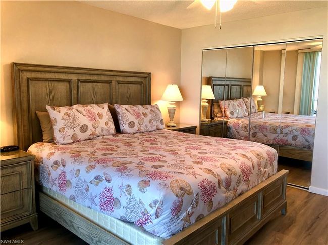 Bedroom with a ceiling fan, dark wood-style floors, and a closet | Image 13