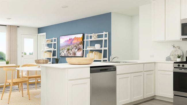 Kitchen featuring appliances with stainless steel finishes, a peninsula, white cabinets, and light countertops | Image 5