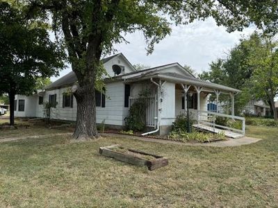 View of front of home featuring covered porch and a front yard | Image 2