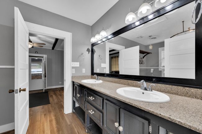 Bathroom featuring wood finished floors, double vanity, and ceiling fan | Image 12