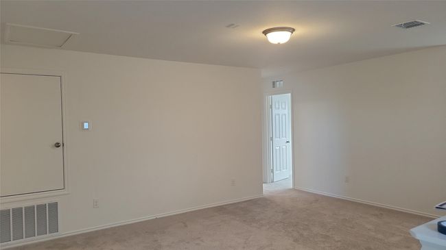 Spare room featuring visible vents, light carpet, and baseboards | Image 8