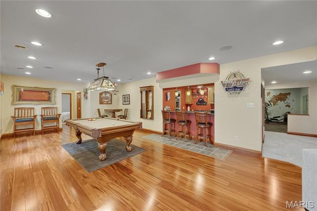 Recreation room featuring bar area, light wood-type flooring, recessed lighting, and billiards | Image 48