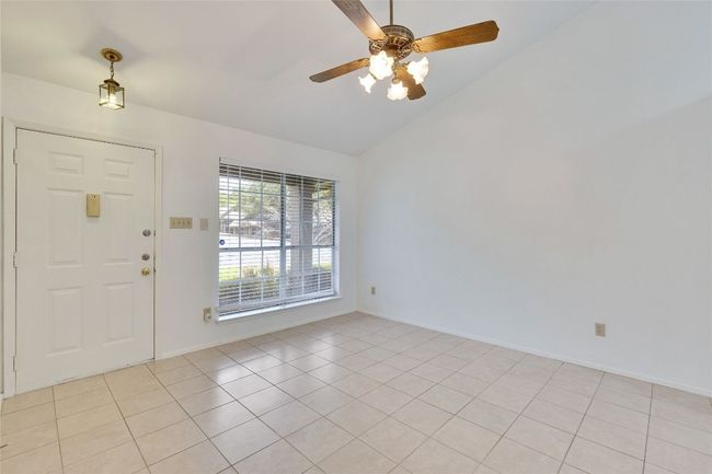 Foyer entrance with lofted ceiling, ceiling fan, and light tile patterned floors | Image 6