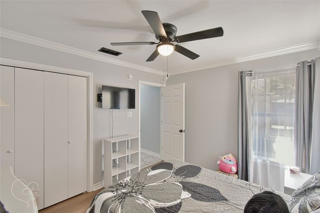 Bedroom featuring crown molding, ceiling fan, and a closet | Image 17